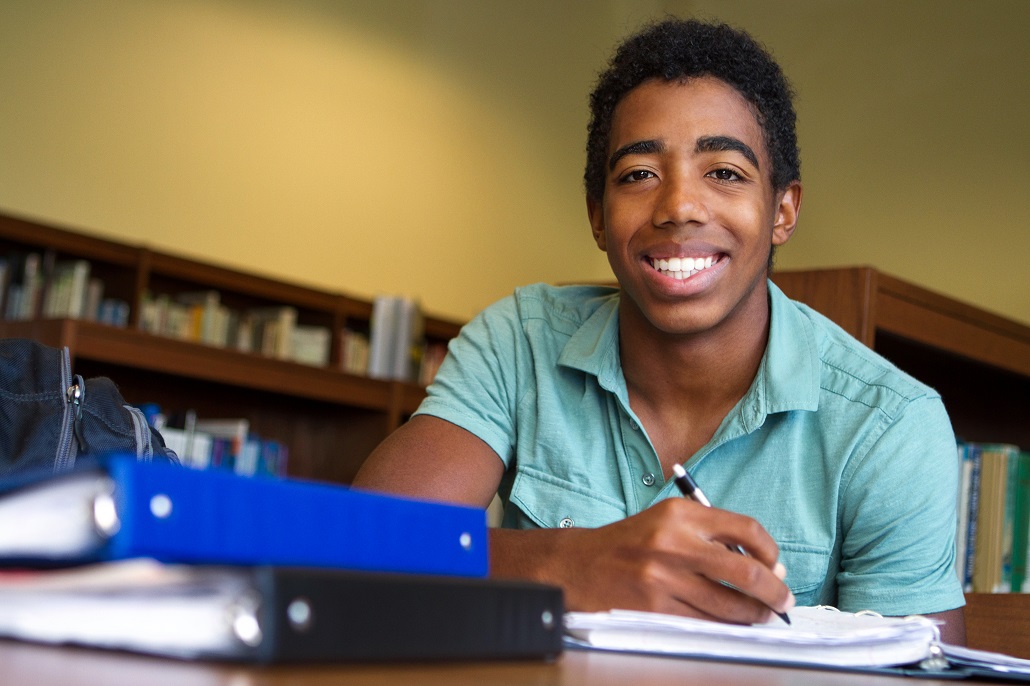 A student in the library working on the FAFSA