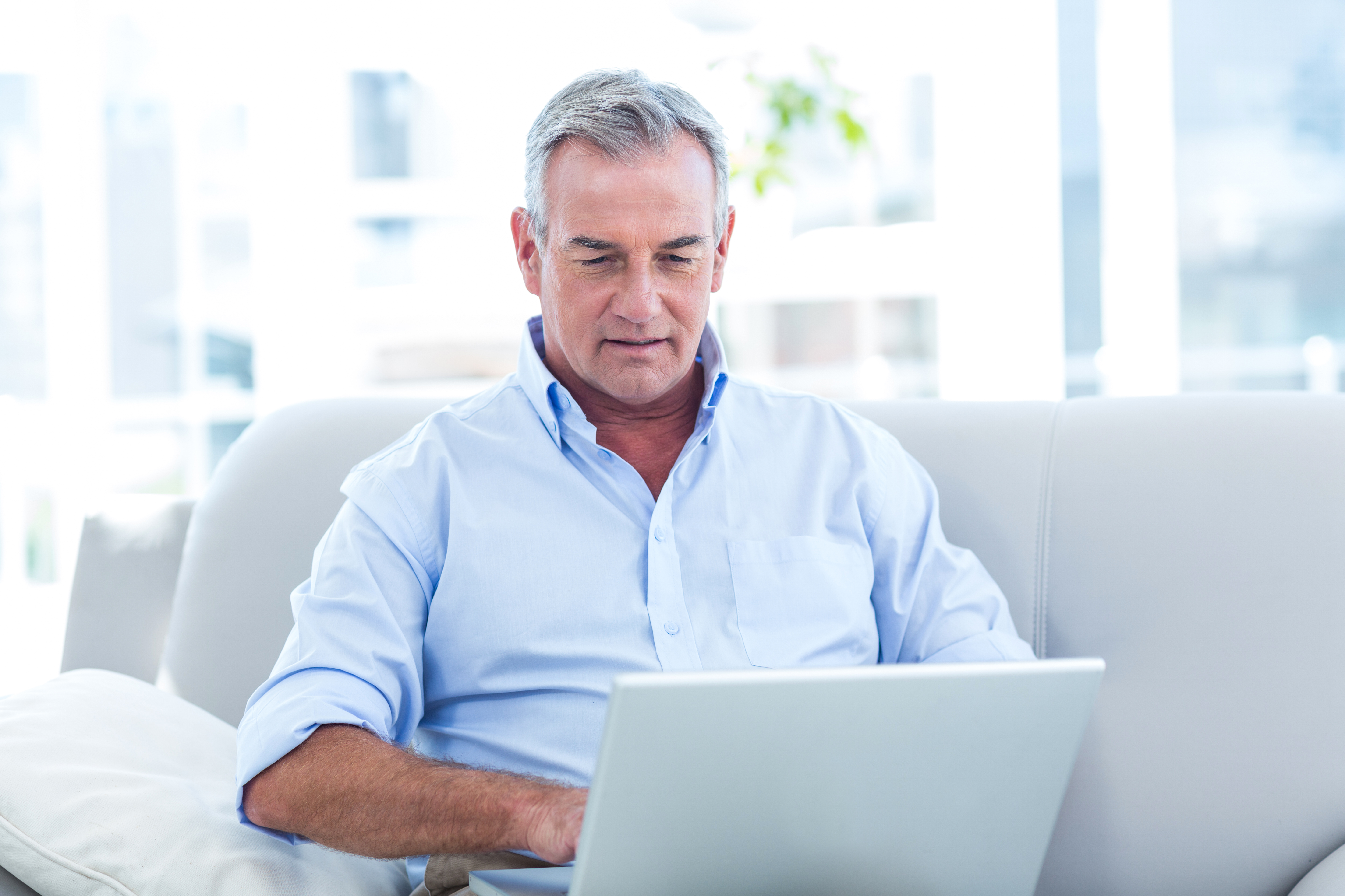 Man using laptop to learn about College Savings Accounts and Financial Aid