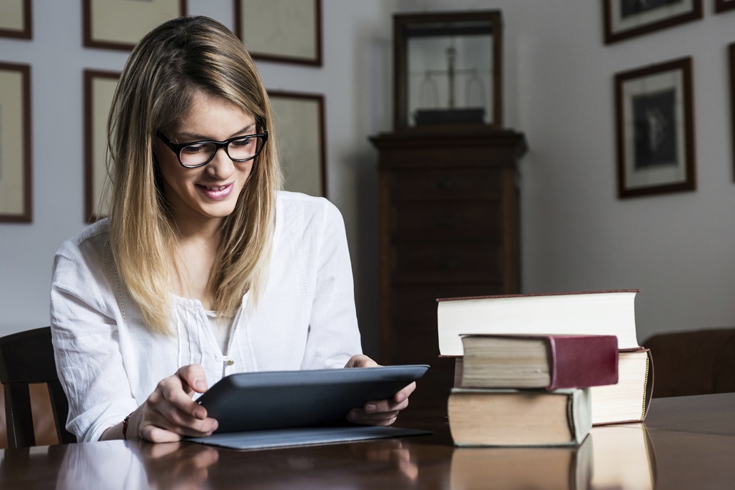 Woman using tablet to apply to scholarships