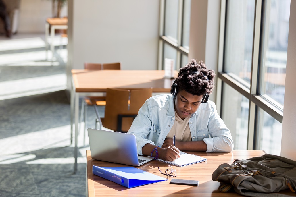 Student using laptop to learn about scholarships for minority students