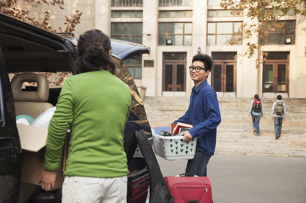 Mother and son unpacking on a college campus