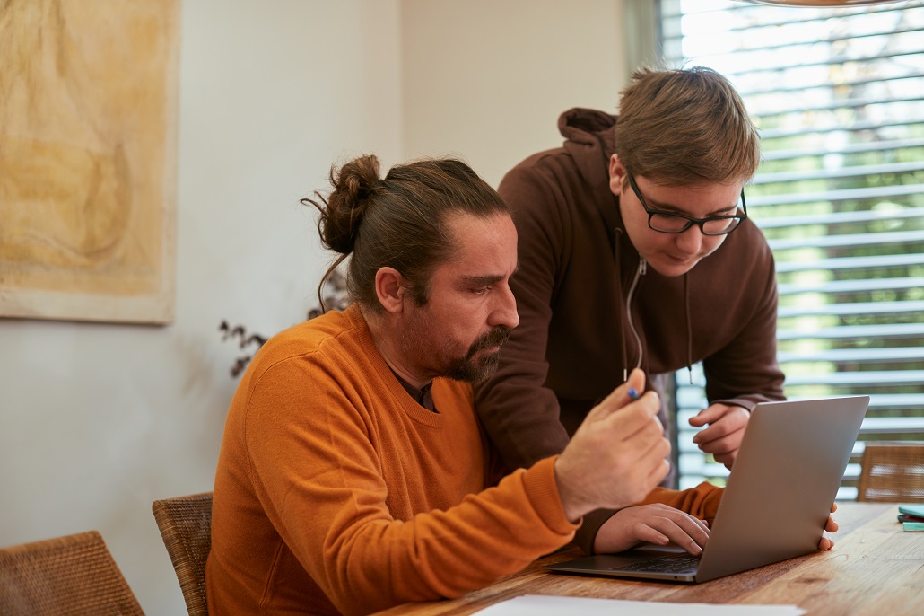 father and son using computer to get answers to questions about student loans