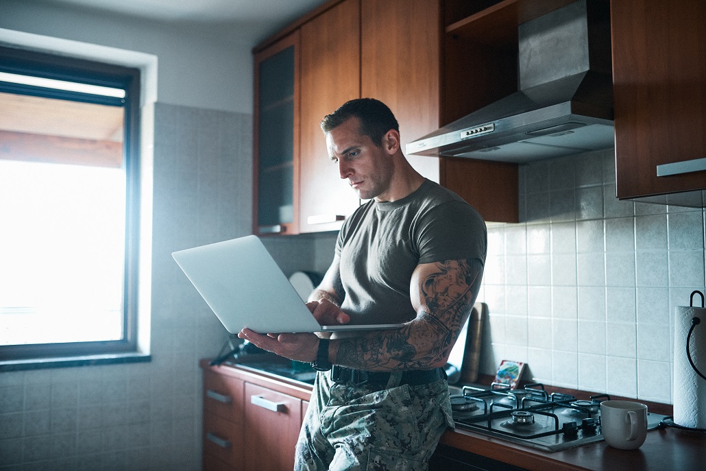 Man using laptop to learn about VA benefits and Attainable savings accounts