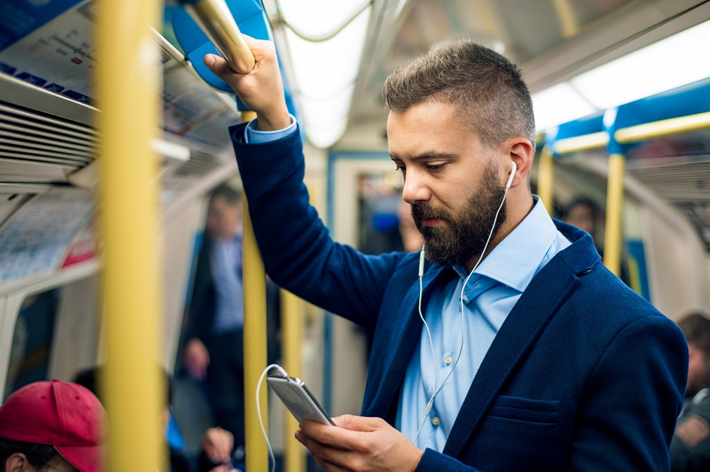 Man on train using his phone